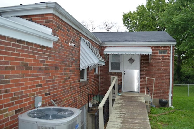 3520 Wismer Rd, Breckenridge Hills, MO 63074 - view of exterior entry featuring brick siding and central AC
