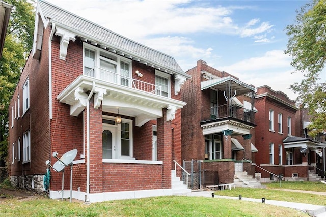 4219 Red Bud Ave, Saint Louis, MO 63115 - view of front of house with brick siding, a balcony, and a front yard