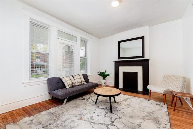 4219 Red Bud Ave, Saint Louis, MO 63115 - living area featuring wood finished floors, baseboards, and a brick fireplace