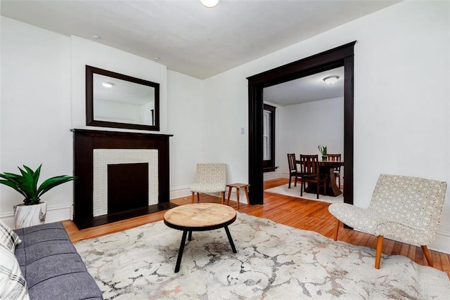 4219 Red Bud Ave, Saint Louis, MO 63115 - living room featuring wood finished floors and a brick fireplace