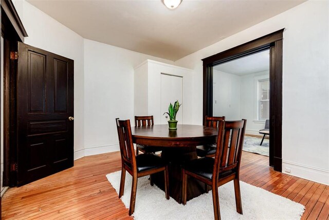 4219 Red Bud Ave, Saint Louis, MO 63115 - dining area featuring light wood-type flooring and baseboards