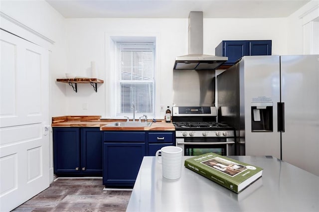 4219 Red Bud Ave, Saint Louis, MO 63115 - kitchen featuring wall chimney range hood, blue cabinetry, wood counters, and a sink