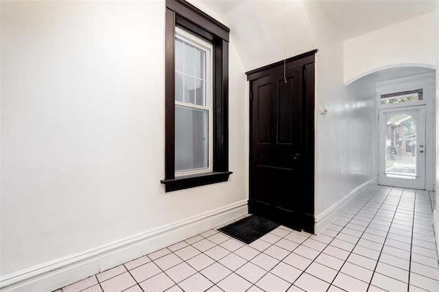 4219 Red Bud Ave, Saint Louis, MO 63115 - foyer with light tile patterned floors, baseboards, and arched walkways