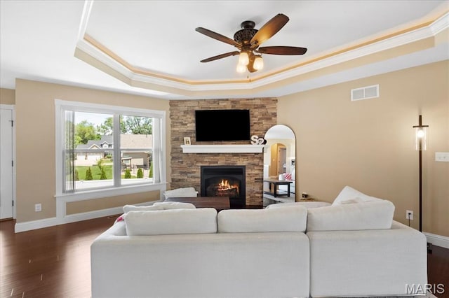 8743 Cardinal Creek Dr, Saint Jacob, IL 62281 - living room featuring a tray ceiling, ceiling fan, dark wood finished floors, a fireplace, and ornamental molding