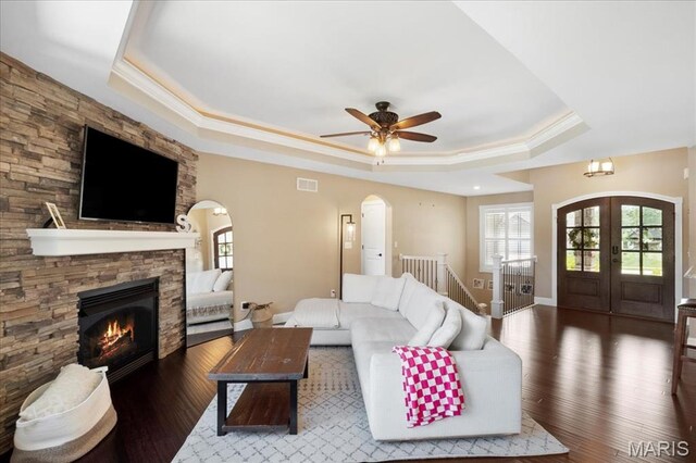 8743 Cardinal Creek Dr, Saint Jacob, IL 62281 - living room featuring a tray ceiling, french doors, wood finished floors, a fireplace, and ornamental molding