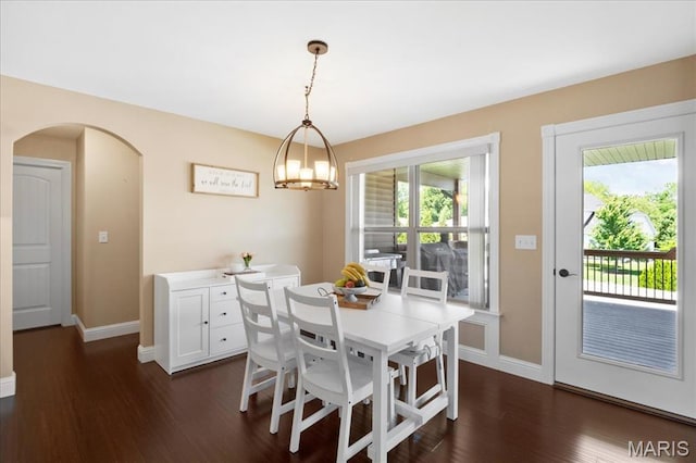 8743 Cardinal Creek Dr, Saint Jacob, IL 62281 - dining area with baseboards, dark wood-style floors, and arched walkways