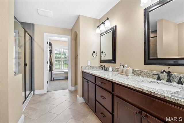8743 Cardinal Creek Dr, Saint Jacob, IL 62281 - bathroom featuring double vanity, a stall shower, baseboards, and tile patterned floors