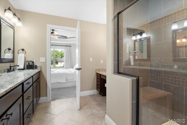 8743 Cardinal Creek Dr, Saint Jacob, IL 62281 - ensuite bathroom featuring vanity, ceiling fan, tiled shower, baseboards, and tile patterned floors