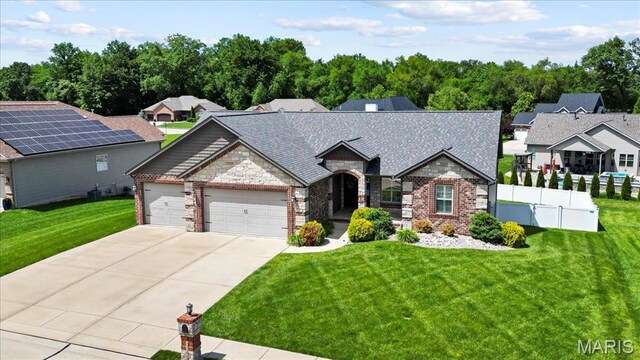 8743 Cardinal Creek Dr, Saint Jacob, IL 62281 - view of front of home featuring driveway, an attached garage, stone siding, and brick siding