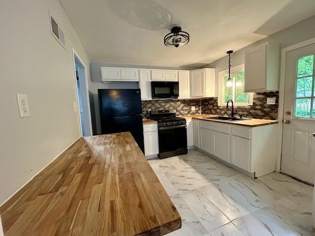 1157 June Ave, Saint Louis, MO 63138 - kitchen featuring black appliances, a sink, butcher block countertops, backsplash, and white cabinets