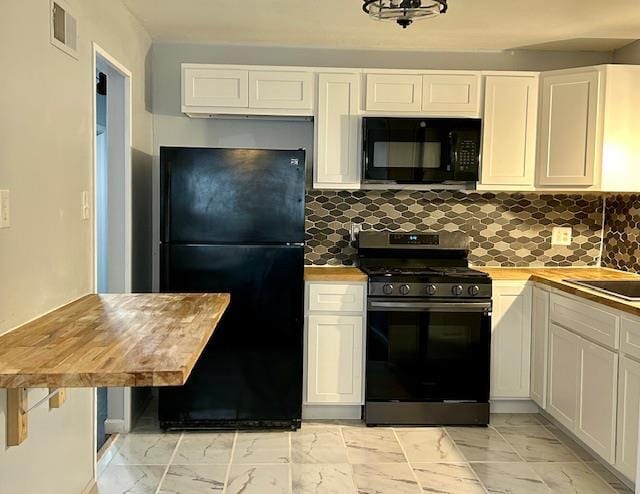 1157 June Ave, Saint Louis, MO 63138 - kitchen with black appliances, light marble finish flooring, wood counters, and white cabinets