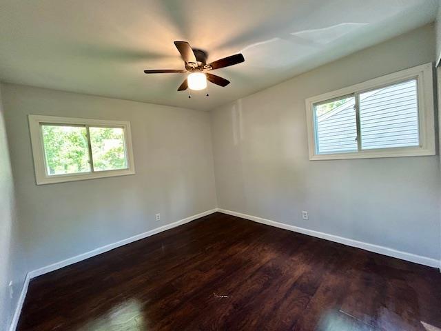 1157 June Ave, Saint Louis, MO 63138 - unfurnished room with baseboards, dark wood-style floors, healthy amount of natural light, and a ceiling fan