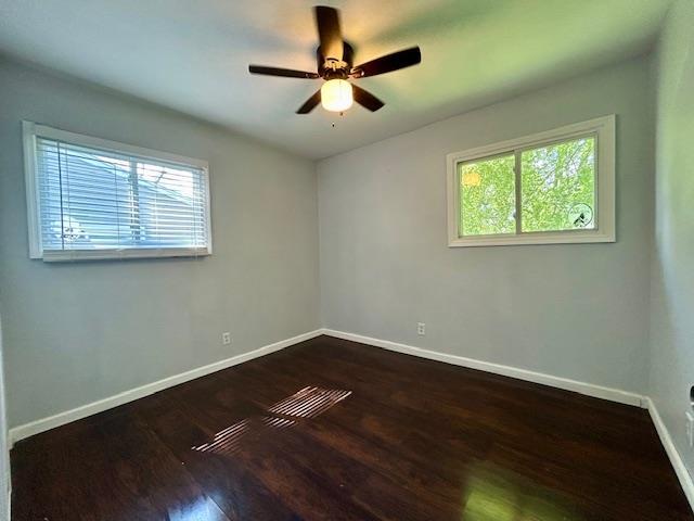 1157 June Ave, Saint Louis, MO 63138 - empty room featuring baseboards, dark wood finished floors, and a ceiling fan