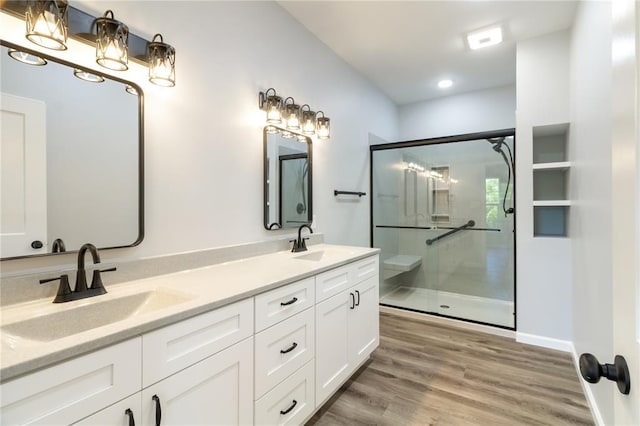 14682 N State Highway 21, Cadet, MO 63630 - bathroom with double vanity, a shower with shower door, wood finished floors, recessed lighting, and baseboards