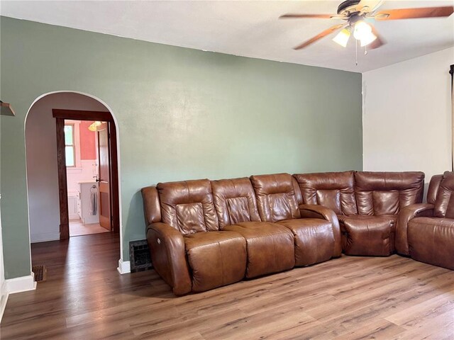 1106 Raab Ave, Belleville, IL 62220 - living area with ceiling fan, arched walkways, wood finished floors, washer / dryer, and baseboards