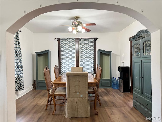 1106 Raab Ave, Belleville, IL 62220 - dining space featuring arched walkways, a ceiling fan, and wood finished floors