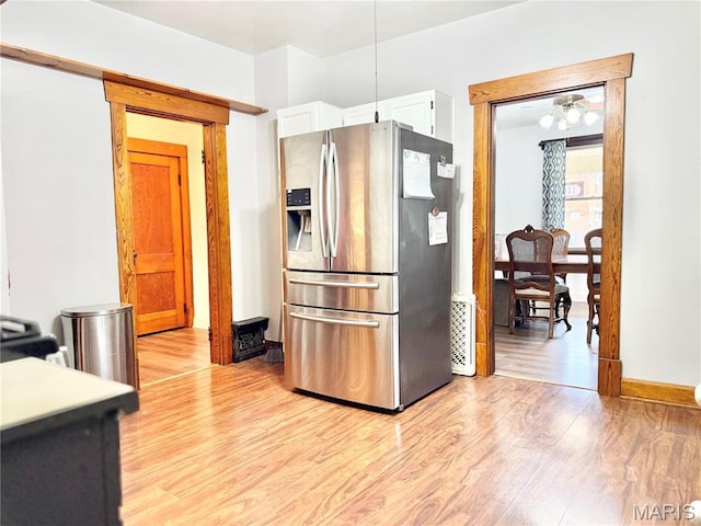 1106 Raab Ave, Belleville, IL 62220 - kitchen featuring stainless steel refrigerator with ice dispenser, light wood-type flooring, white cabinets, and baseboards