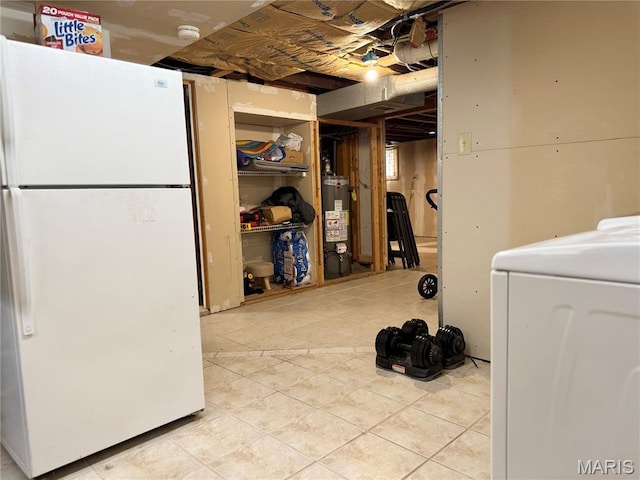 1106 Raab Ave, Belleville, IL 62220 - unfinished below grade area featuring freestanding refrigerator, washer / dryer, light tile patterned floors, and gas water heater