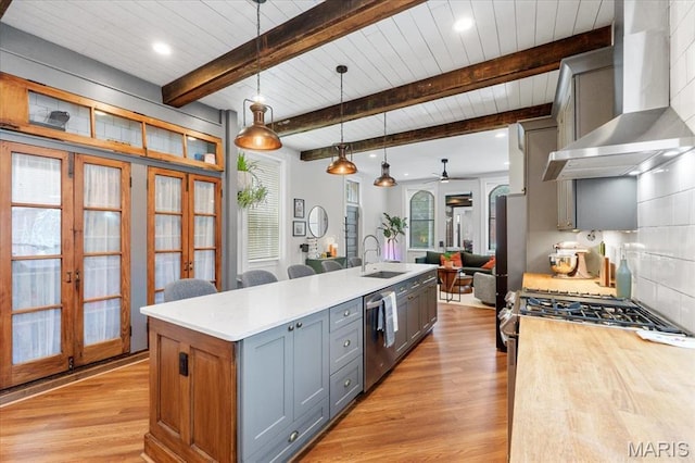 2000 Withnell Ave, Saint Louis, MO 63118 - kitchen featuring wall chimney exhaust hood, open floor plan, a sink, dishwasher, and french doors