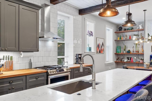 2000 Withnell Ave, Saint Louis, MO 63118 - kitchen featuring wall chimney exhaust hood, gray cabinets, a sink, gas stove, and tasteful backsplash