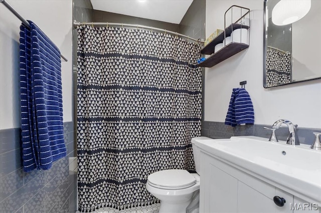 2000 Withnell Ave, Saint Louis, MO 63118 - bathroom with tile walls, toilet, vanity, curtained shower, and a wainscoted wall