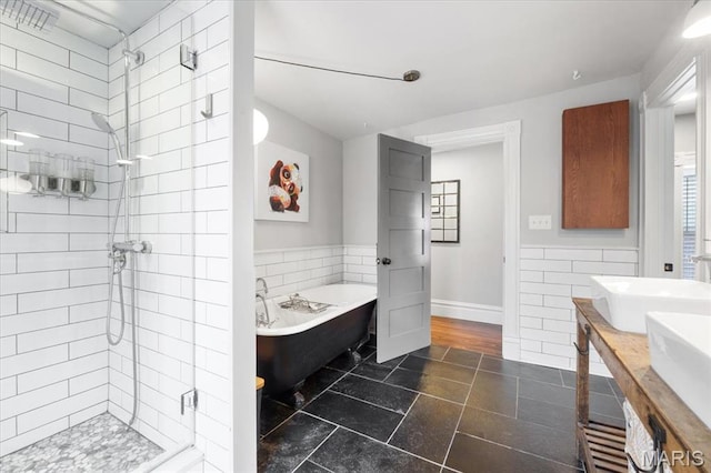 2000 Withnell Ave, Saint Louis, MO 63118 - bathroom featuring a stall shower, a freestanding bath, tile walls, double vanity, and baseboards