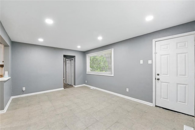 1901 Bainbridge Dr, Saint Louis, MO 63133 - unfurnished living room with baseboards and recessed lighting