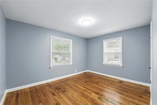 1901 Bainbridge Dr, Saint Louis, MO 63133 - spare room featuring baseboards and wood finished floors