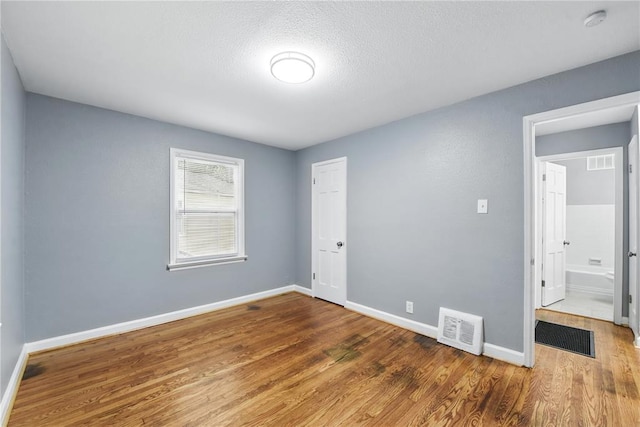 1901 Bainbridge Dr, Saint Louis, MO 63133 - unfurnished room featuring wood finished floors, baseboards, a smoke detector, and a textured ceiling