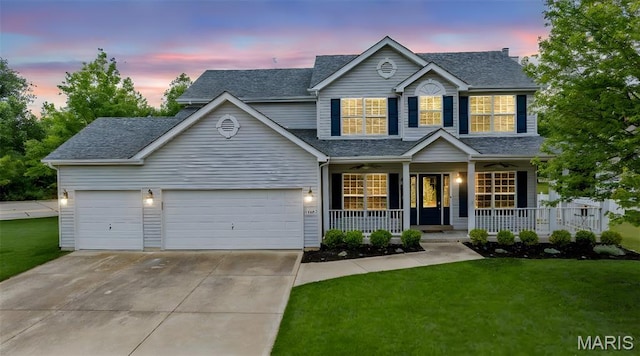 102 Riparian Dr, Ofallon, MO 63368 - traditional-style home with a porch, driveway, a garage, a lawn, and a shingled roof