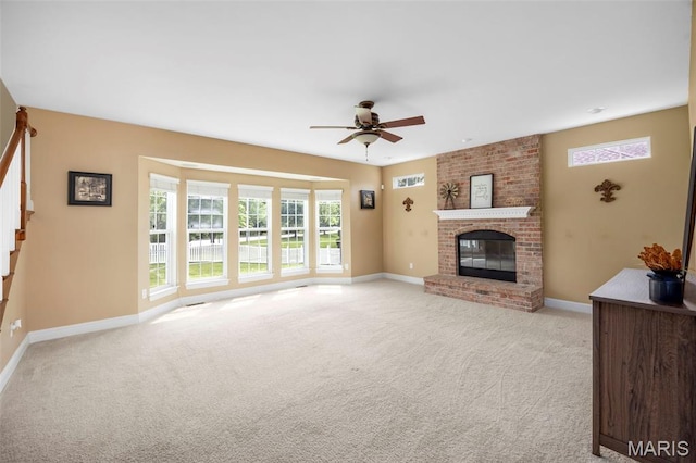 102 Riparian Dr, Ofallon, MO 63368 - unfurnished living room featuring a ceiling fan, light colored carpet, and baseboards