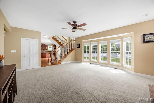 102 Riparian Dr, Ofallon, MO 63368 - unfurnished living room featuring stairs, carpet floors, baseboards, and ceiling fan
