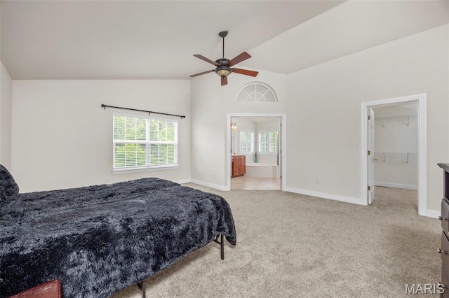 102 Riparian Dr, Ofallon, MO 63368 - carpeted bedroom featuring baseboards, a walk in closet, high vaulted ceiling, ensuite bathroom, and a ceiling fan