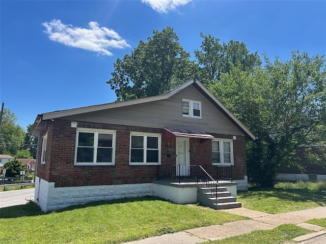 3838 Avondale Ave, Northwoods, MO 63121 - bungalow-style home featuring a front lawn and brick siding