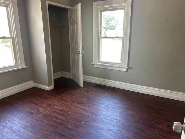 3838 Avondale Ave, Northwoods, MO 63121 - unfurnished bedroom with dark wood-type flooring, baseboards, and a closet