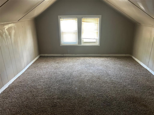 3838 Avondale Ave, Northwoods, MO 63121 - additional living space featuring vaulted ceiling, carpet, wooden walls, and baseboards
