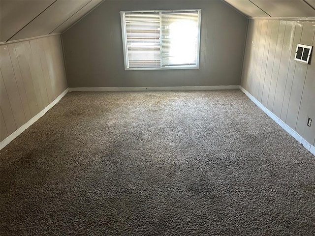 3838 Avondale Ave, Northwoods, MO 63121 - bonus room with vaulted ceiling, carpet flooring, baseboards, and wooden walls