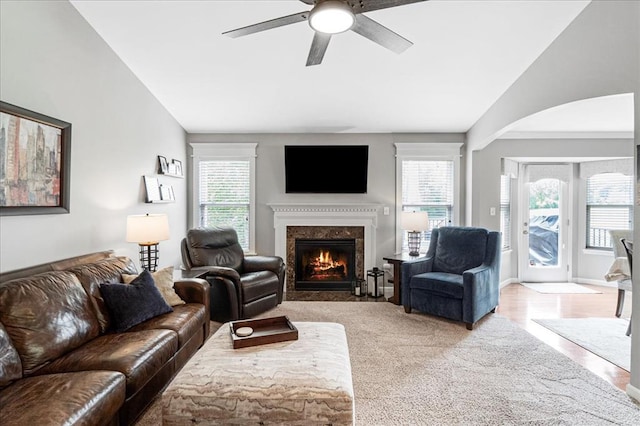 1456 Red Oak Plantation Dr, Ballwin, MO 63021 - living room with vaulted ceiling, a high end fireplace, ceiling fan, arched walkways, and carpet floors