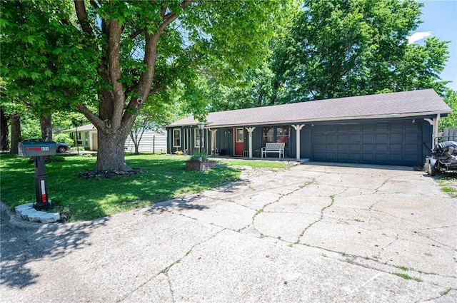 606 N Charles Ave, St James, MO 65559 - ranch-style house with an attached garage, a front yard, asphalt driveway, a porch, and roof with shingles