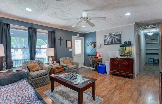 606 N Charles Ave, St James, MO 65559 - living area with ornamental molding, a textured ceiling, light wood-style floors, ceiling fan, and baseboards