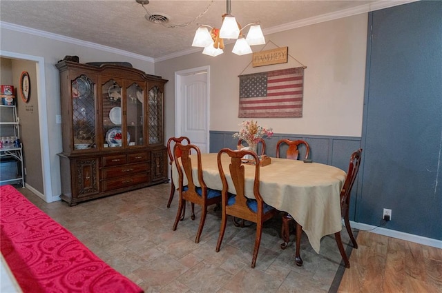 606 N Charles Ave, St James, MO 65559 - dining area featuring crown molding, a chandelier, and wainscoting