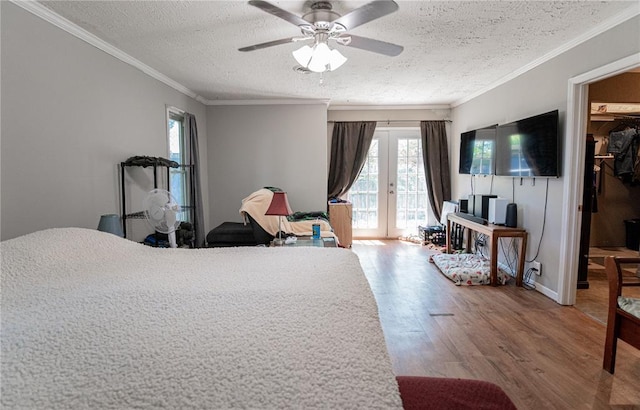 606 N Charles Ave, St James, MO 65559 - bedroom with a textured ceiling, french doors, access to outside, multiple windows, and wood finished floors