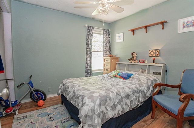 606 N Charles Ave, St James, MO 65559 - bedroom with wood finished floors, a ceiling fan, and baseboards