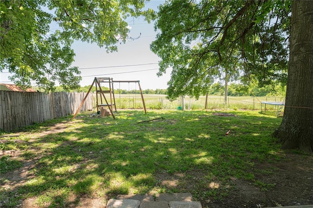 606 N Charles Ave, St James, MO 65559 - view of yard featuring a trampoline and a playground