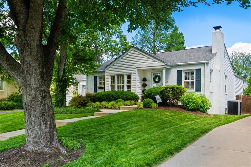 42 Midpark Ln, Ladue, MO 63124 - view of front of property featuring a front lawn, a chimney, central AC unit, and roof with shingles