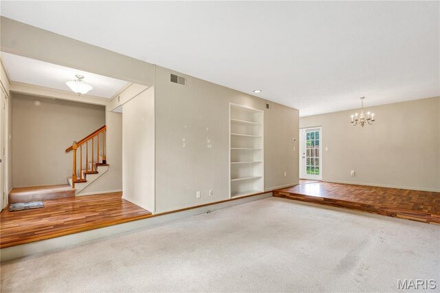 13489 Beaulac Dr, Chesterfield, MO 63141 - carpeted spare room featuring baseboards, built in features, a chandelier, and stairs