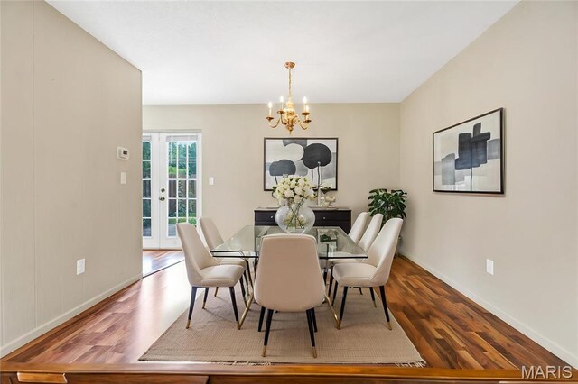 13489 Beaulac Dr, Chesterfield, MO 63141 - dining room with wood finished floors, a chandelier, baseboards, and french doors
