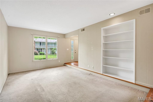 13489 Beaulac Dr, Chesterfield, MO 63141 - carpeted empty room with baseboards and built in shelves