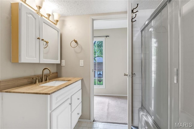 13489 Beaulac Dr, Chesterfield, MO 63141 - full bathroom featuring vanity, a textured ceiling, tile patterned floors, baseboards, and a shower