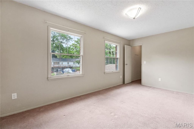 13489 Beaulac Dr, Chesterfield, MO 63141 - spare room with light carpet, a textured ceiling, and baseboards